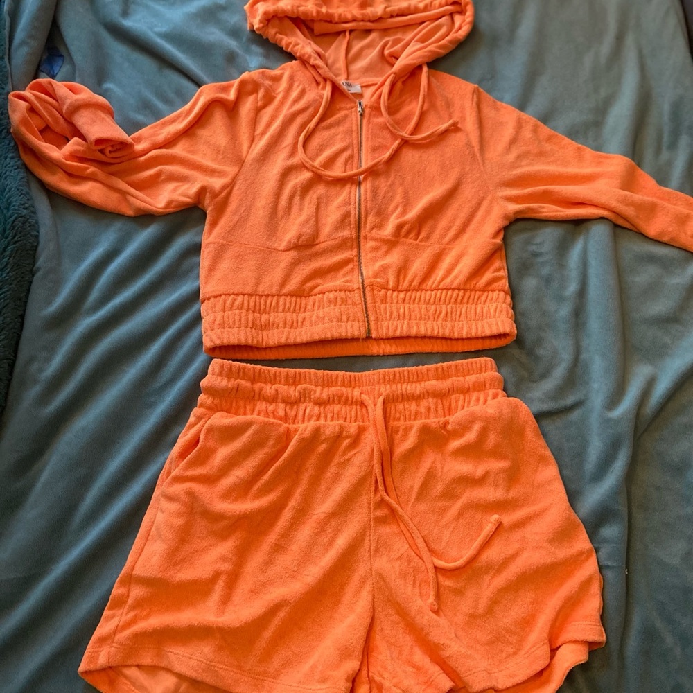 Orange two piece shirt and jacket set.